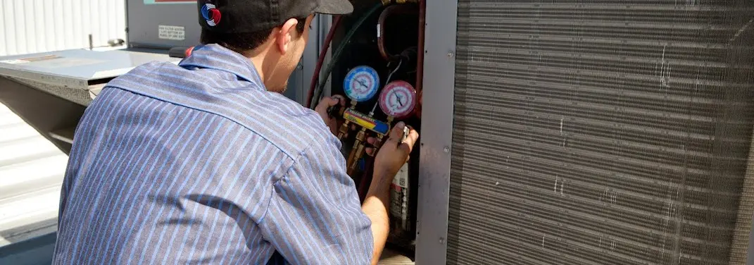 HVAC technician servicing a condenser unit in Napa