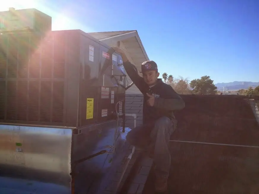 HVAC technician performing HVAC Inspection on a rooftop unit in Napa